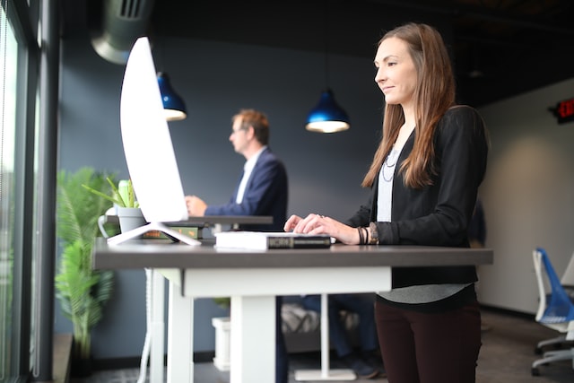 Two people working on a standing desk